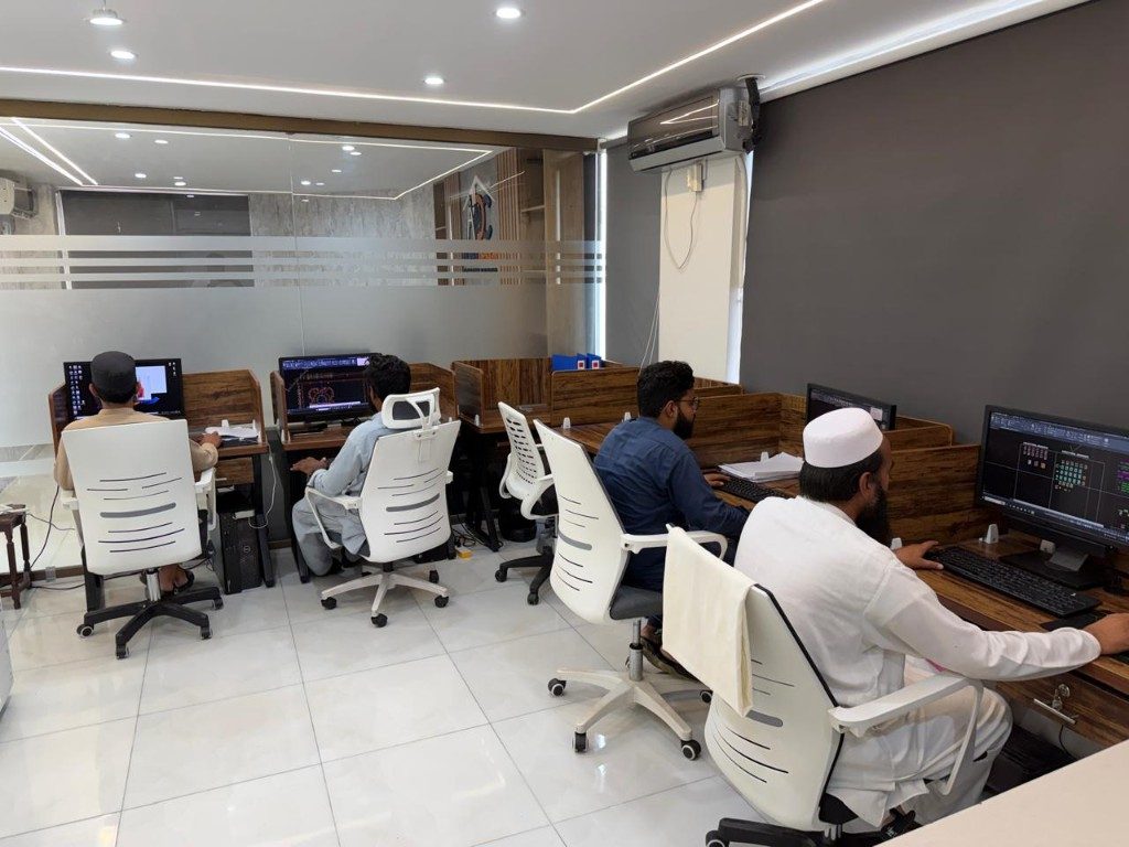 Engineering team working on structural CAD drawings at the office workstations